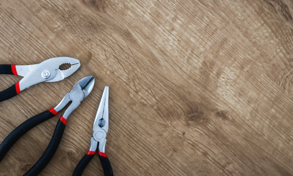 a selection of tools on a wooden background