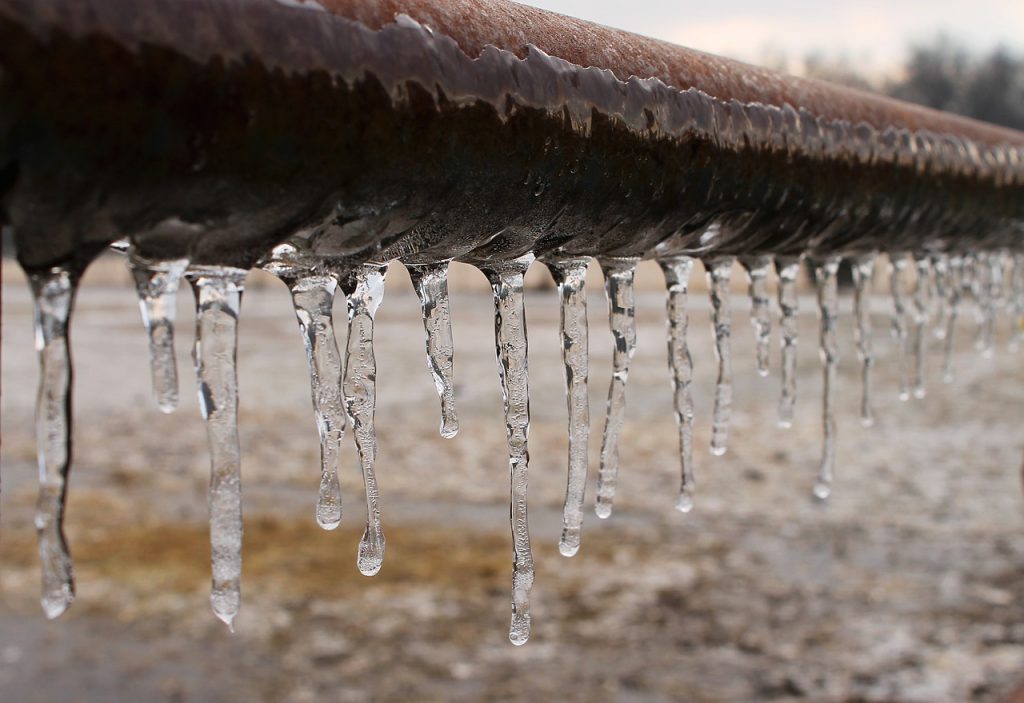 icicles hanging from a frozen pipe