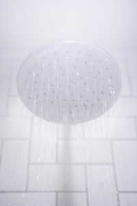steamy shower head running water